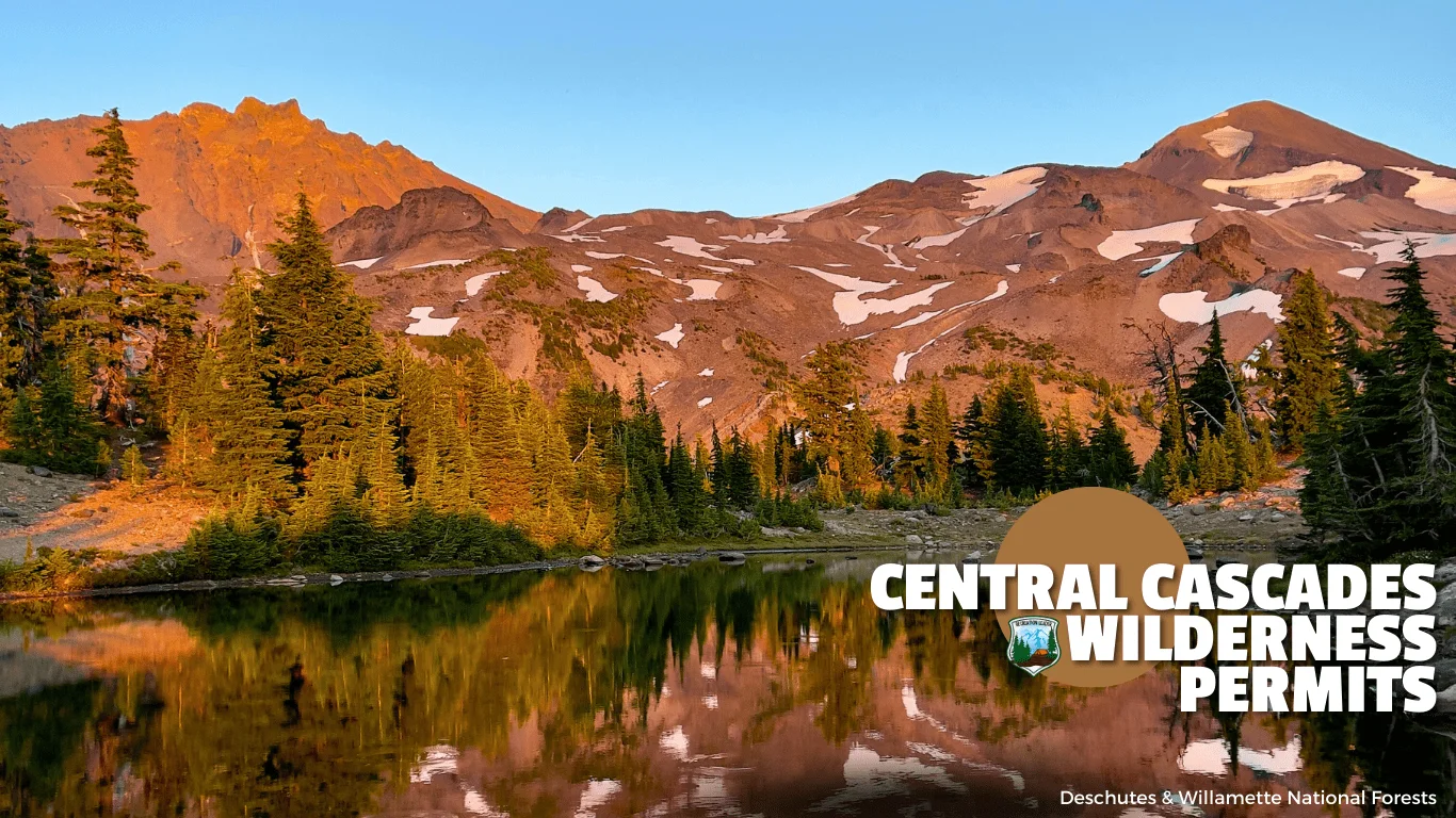 Scenic view of Central Cascades Wilderness with snow-capped mountains, evergreen trees, and a reflective lake at sunset in Deschutes and Willamette National Forests